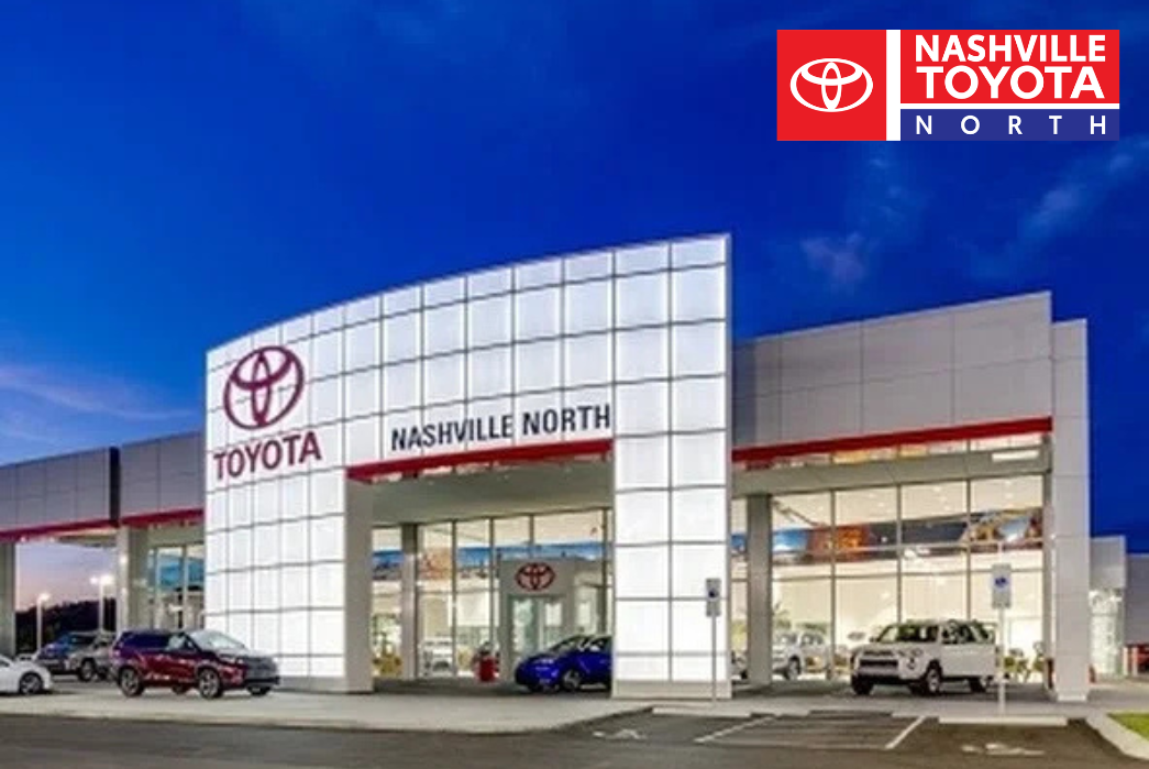 the front of a toyota dealership at dusk