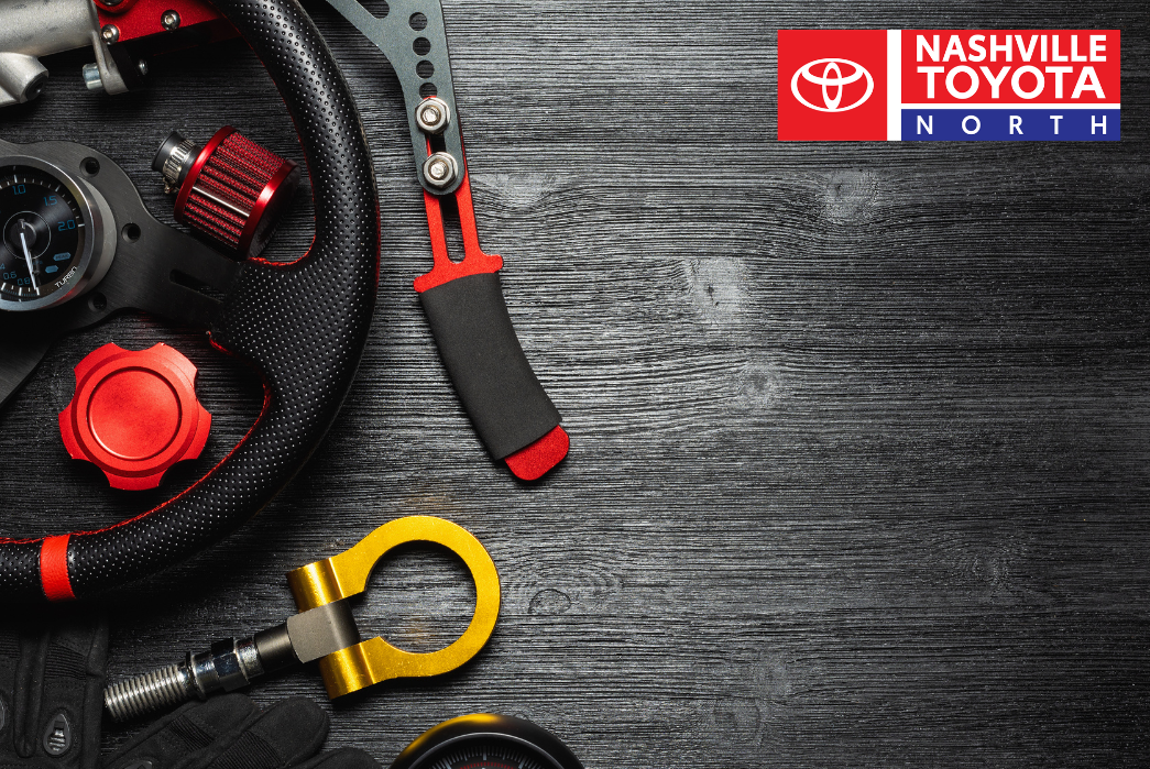 a steering wheel, gauges and other tools on a wooden table