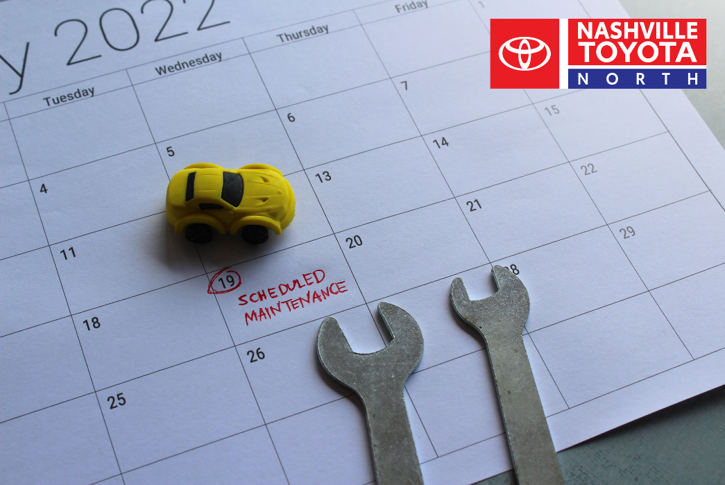 a calendar with wrenches and a toy car on it
