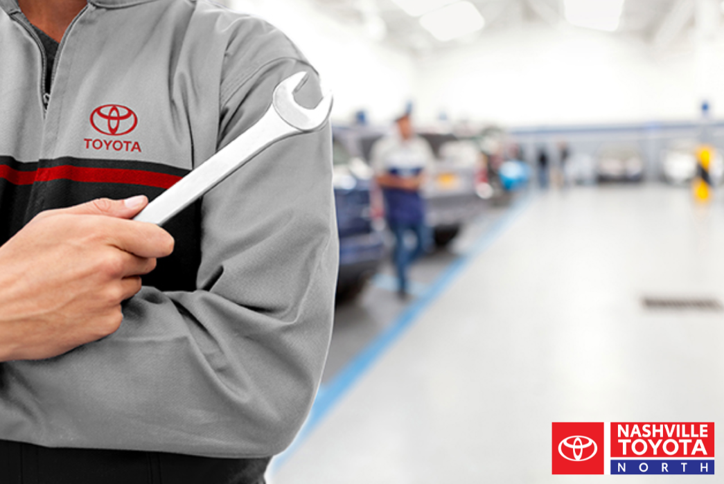 A person holding a wrench in a toyota service center