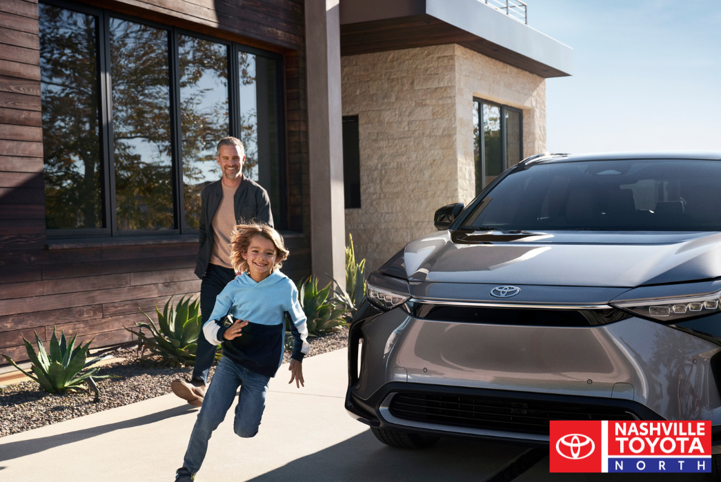 man with child running toyota rav4 hybrid