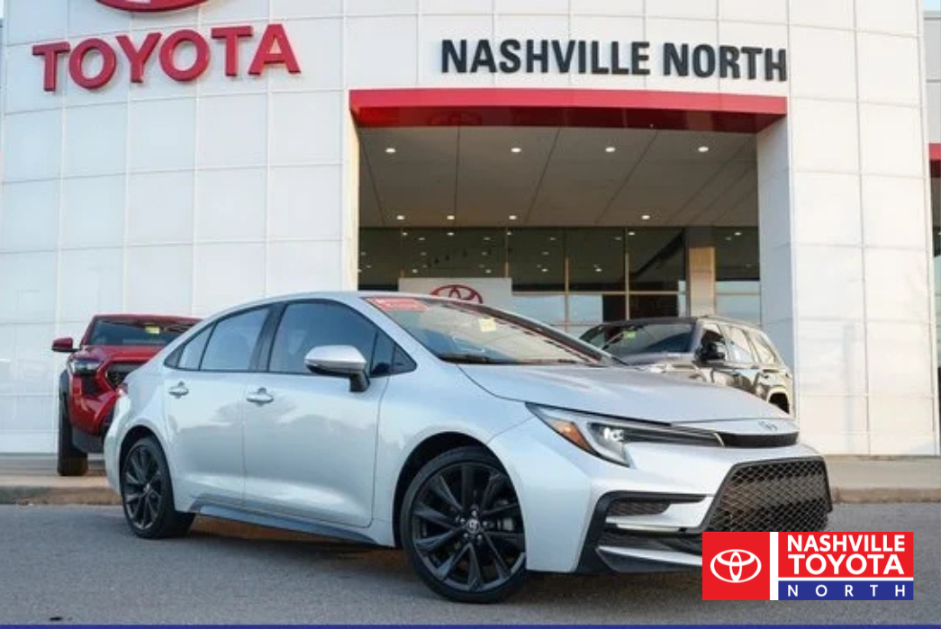A silver Toyota car parked in front of the Nashville Toyota North dealership.